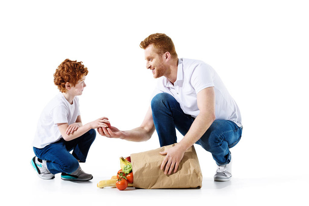 father and son with grocery bag - Foto, imagen