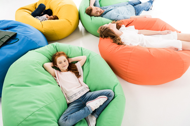 family on bean bag chairs after shopping  - Foto, imagen
