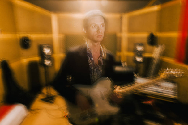 Guitarist creative portrait in recording studio - Photo, image