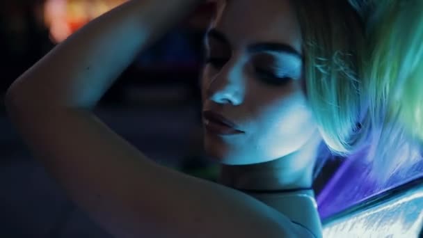 Beautiful sexy woman in blue light outdoor in night city, slow motion - Video, Çekim