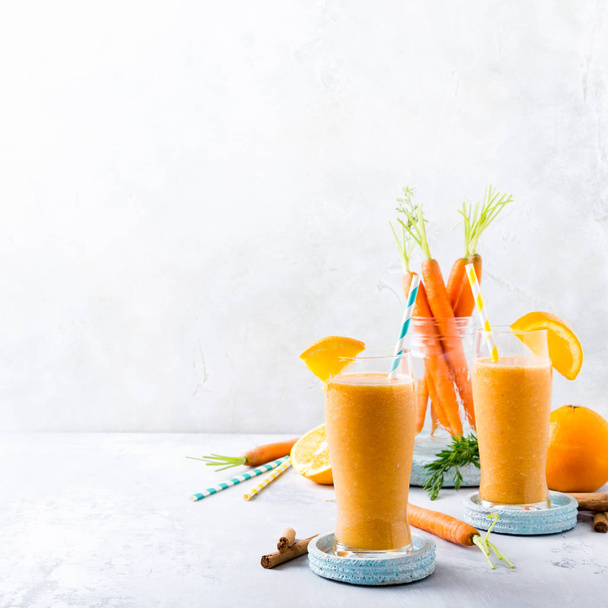 Healthy carrot smoothie with orange and cinnamon in glass - Photo, Image