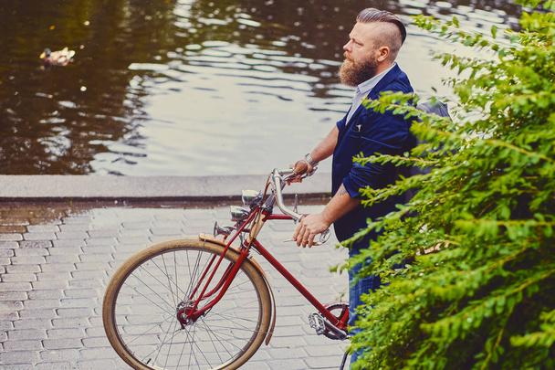 Redhead bearded male on bicycle  - 写真・画像
