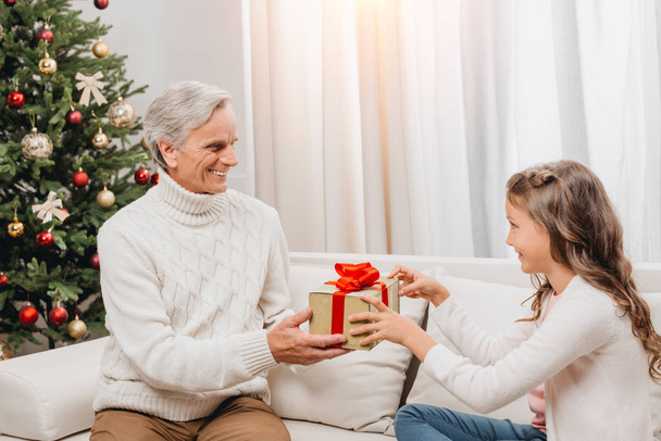 grandfather presenting gift to granddaughter - Photo, Image