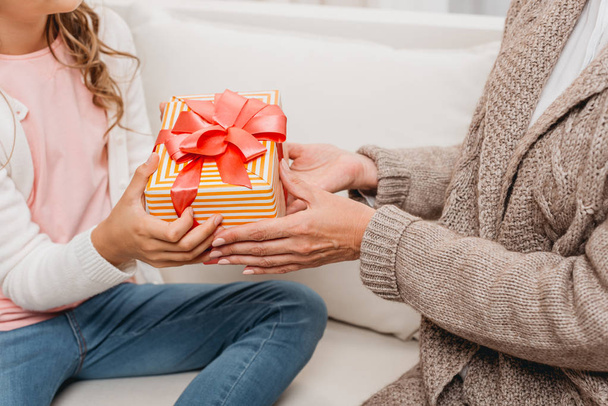 mother presenting gift to daughter - Foto, imagen