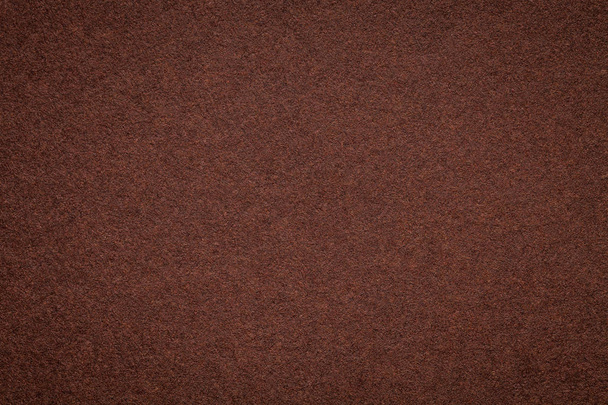 Texture of old dark brown paper background, closeup. Structure of dense umber cardboard - Photo, Image