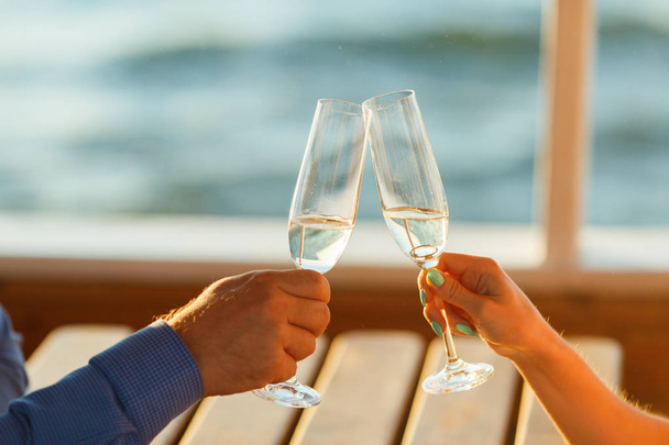 Happy couple drinks champagne on a yacht - Valokuva, kuva
