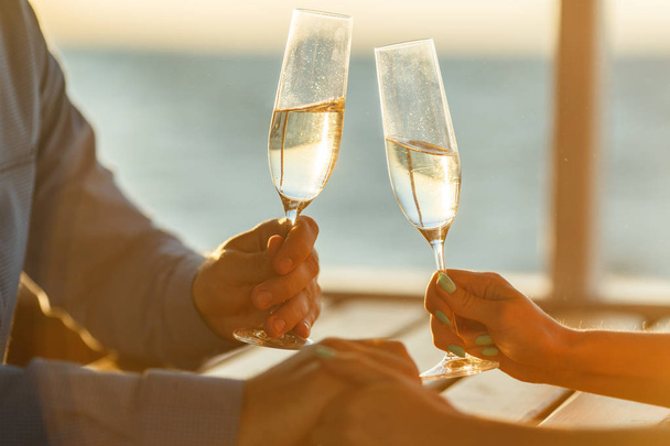Happy couple drinks champagne on a yacht - Fotografie, Obrázek