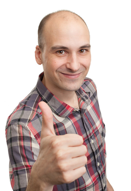 Happy casual young man showing thumb up and smiling - Foto, afbeelding