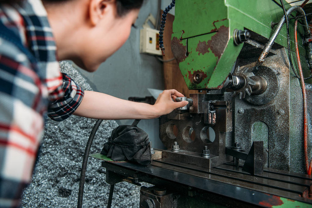 staff put finished parts into industrial machine  - Foto, Bild