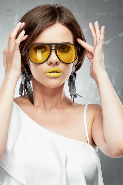 Young woman beauty portrait with yellow sun glasses. - Фото, изображение