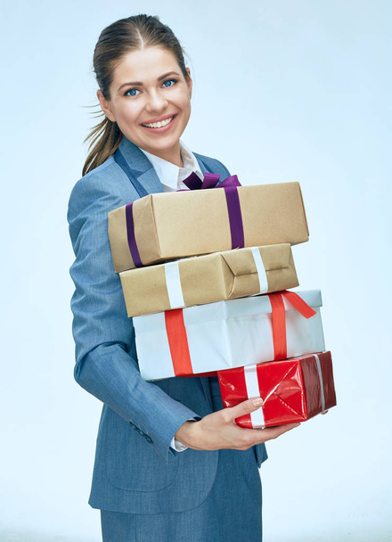 Business woman holding gift boxes. Christmas presents. Smiling g - 写真・画像