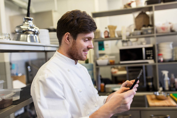 chef cook with tablet pc at restaurant kitchen - Foto, Bild
