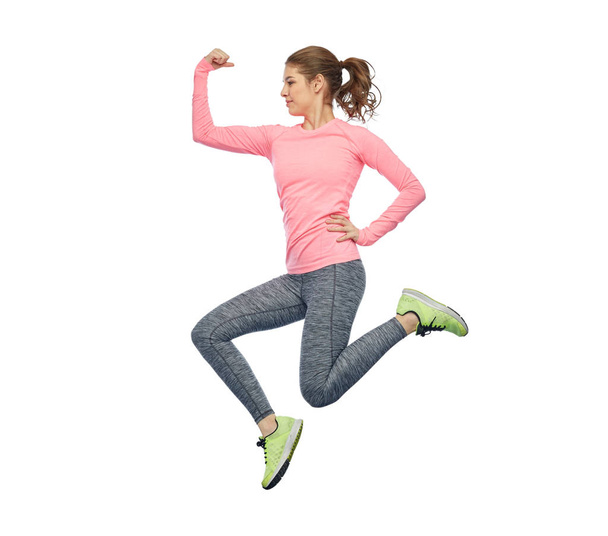 happy smiling sporty young woman jumping in air - Fotoğraf, Görsel