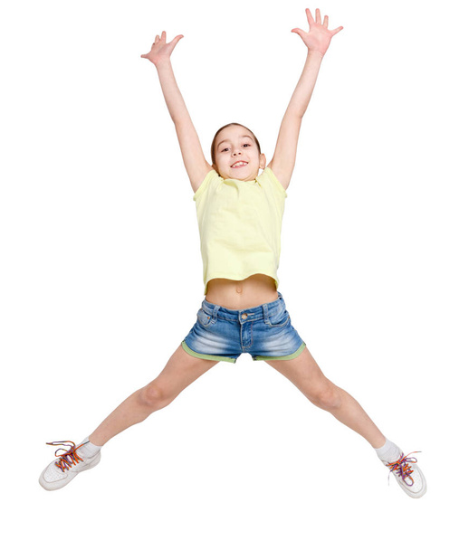Happy teenage girl jumping on white isolated background - Фото, зображення