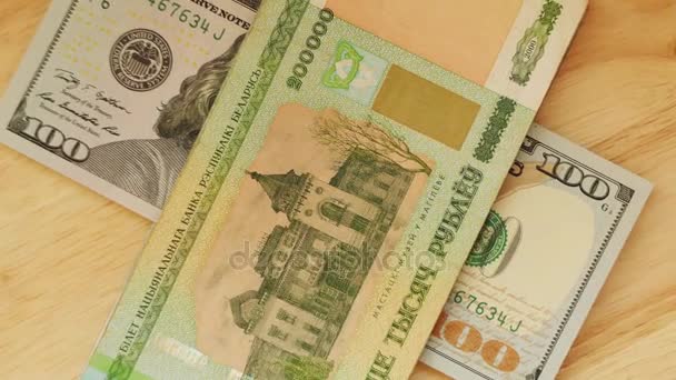 Běloruských rublů par hodnotu dvě stě tisíc lež a americký dolar (americký dolar) na dřevěný stůl. - Záběry, video