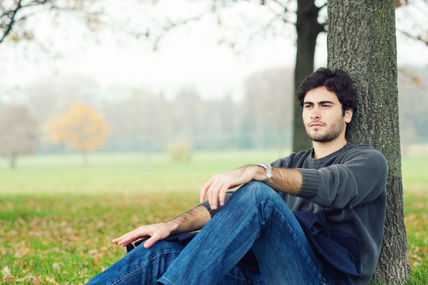 Intimate portrait of man outside in a park - Foto, imagen