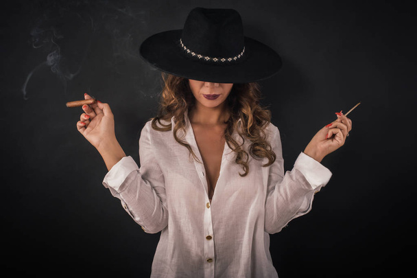 Portrait of sexy elegant lady woman with hat smoking cigar - Photo, image