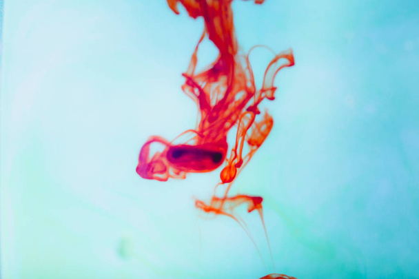 Red ink in water, artistic shot, abstract background - Foto, imagen