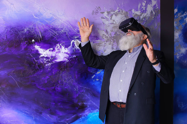 Senior citizen immersed in virtual reality with help of special - Photo, Image
