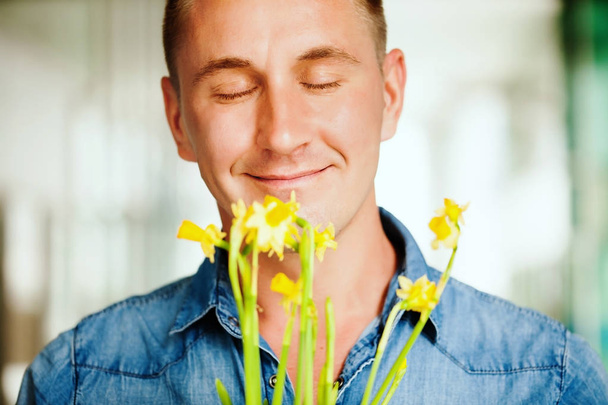 man smelling flowers  - Valokuva, kuva