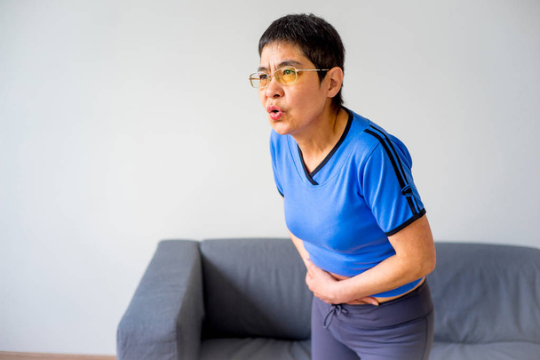 Woman suffering from a stomachache - 写真・画像