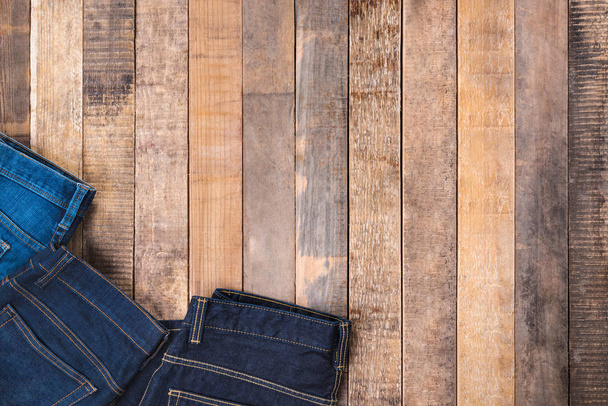 Jeans on wood background - Photo, Image