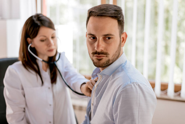 Doctor listening to patients chest  - Photo, Image