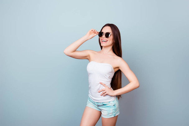 Sunglasses and tourism concept. Young cute brunette lady in summ - 写真・画像