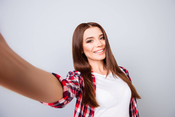 Selfie mania! Attractive young brunette lady is making a selfie  - Фото, изображение