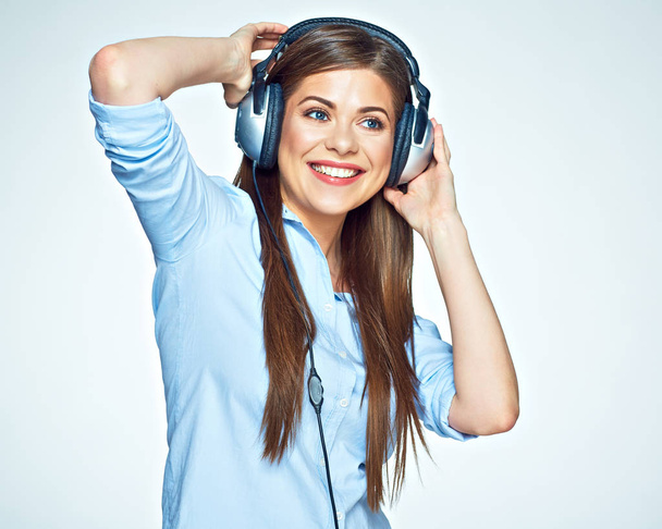 Woman listening music touching headphones. - Foto, immagini