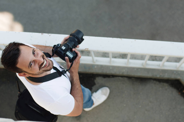 Photographer standing with DSLR camera. - Fotó, kép