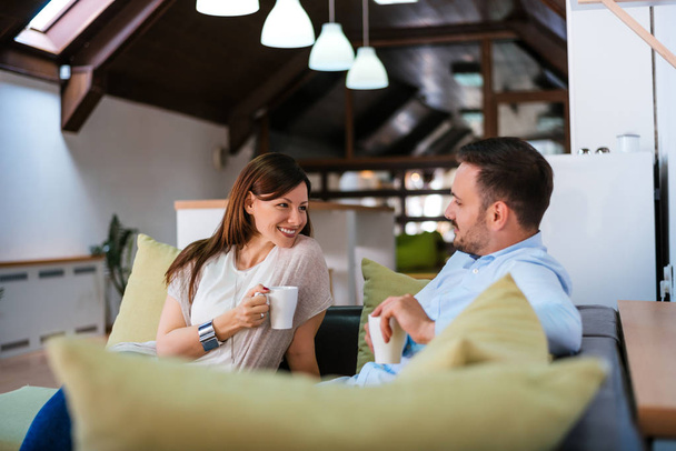 Couple relaxing at home with coffee  - Photo, Image