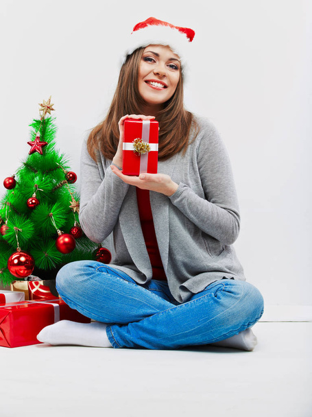 Santa girl isolated portrait with christmas gift, cristmas tree. - Фото, изображение