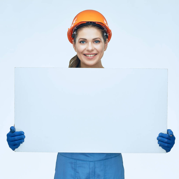 Builder holding white banner with copy space.  - Foto, imagen