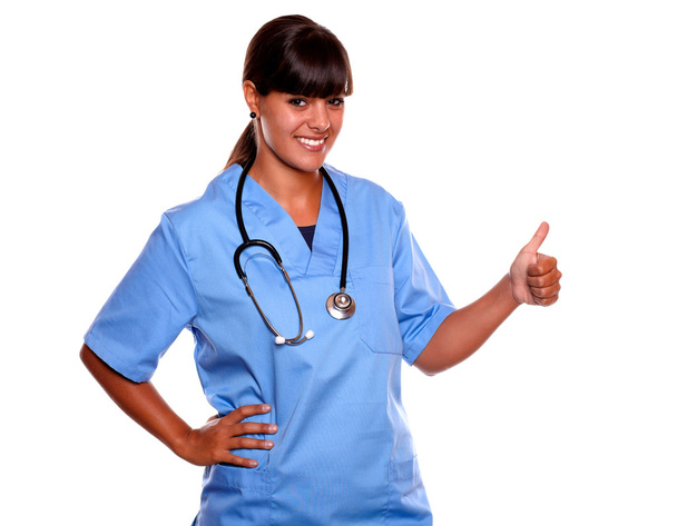 Pretty nurse smiling and showing you ok sign - Foto, imagen