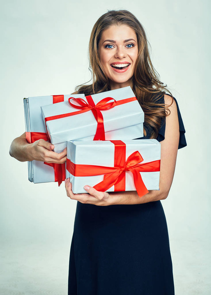 Smiling woman in black evening dress holding gift box. - Foto, afbeelding
