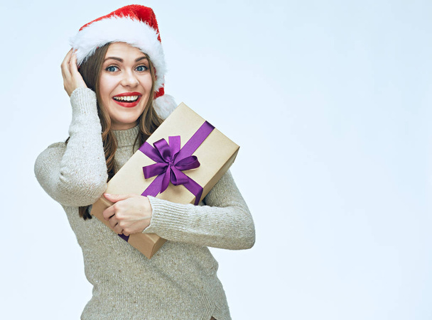 Smiling Santa girl holding gift box.  - Foto, afbeelding