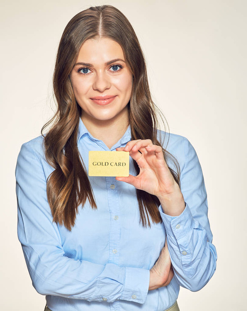 smiling business woman presenting gold credit card. - Photo, image
