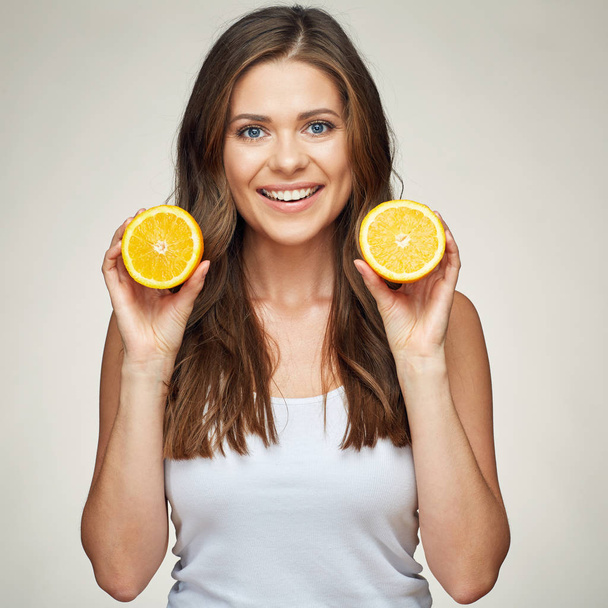 smiling woman holding orange fruit. studio isolated portrait.  - Foto, Bild
