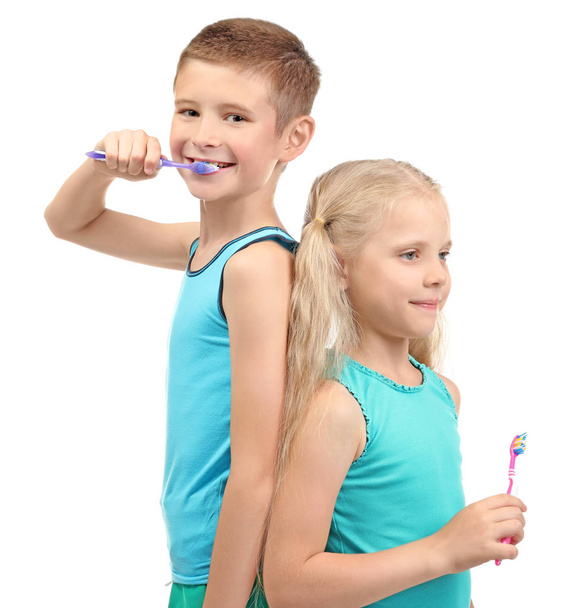 Cute little children cleaning teeth on white background - Photo, Image