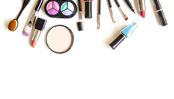 Cosmetics and fashion background with make up artist objects: lipstick, eye shadows, mascara ,eyeliner, concealer, nail polish.  Lifestyle Concept - Photo, Image