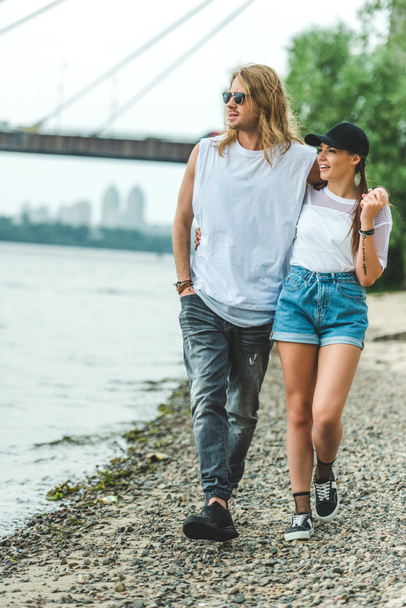 couple walking by river shore - Foto, immagini