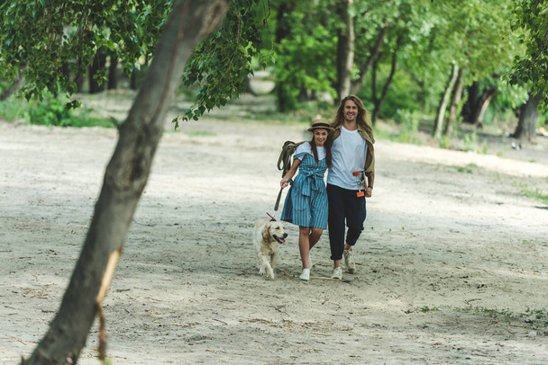 若いカップルの犬と散歩に - 写真・画像