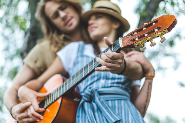 couple with guitar in park - Photo, Image