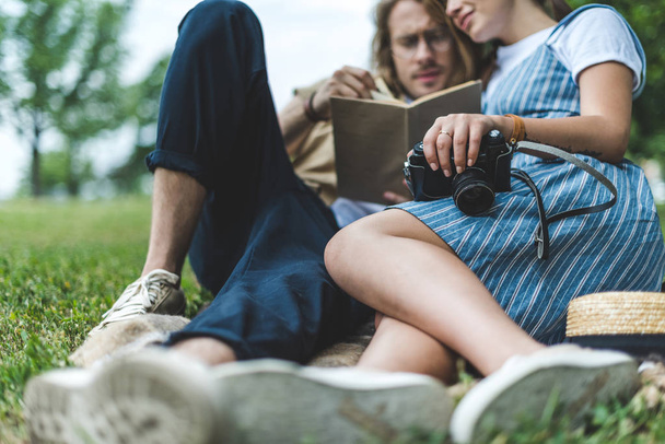 couple reading book in park - Photo, Image