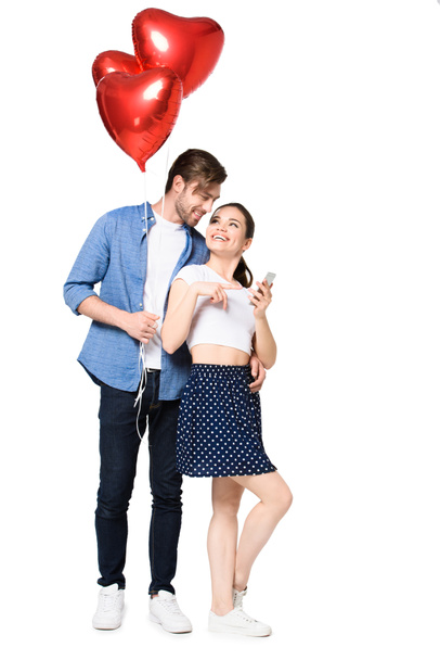 couple with smartphone and balloons  - Photo, Image