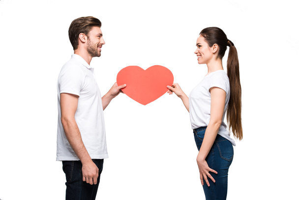 couple holding red heart - Фото, зображення