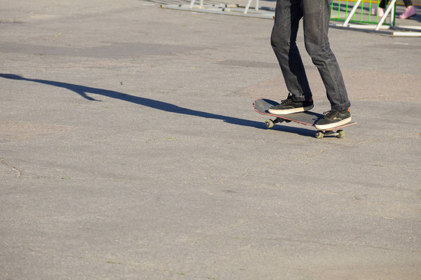 Skateboarder legs riding skateboard  - Photo, Image