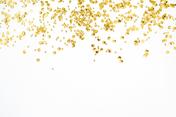 Golden confetti tinsel on white background  - Фото, зображення