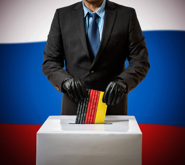 Hombre con guante lanza bandera alemana en caja de voz
 - Foto, Imagen